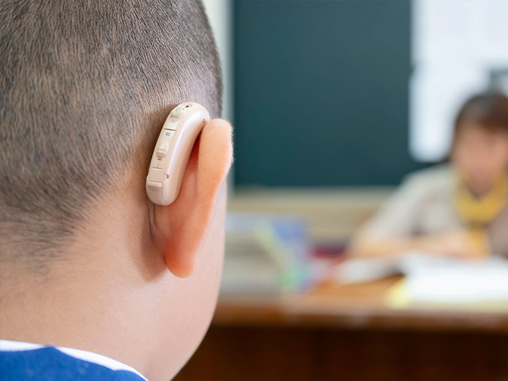 School child with hearing aid